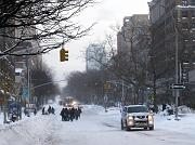  People walking on the street as sidewalk was not plawed yet.
